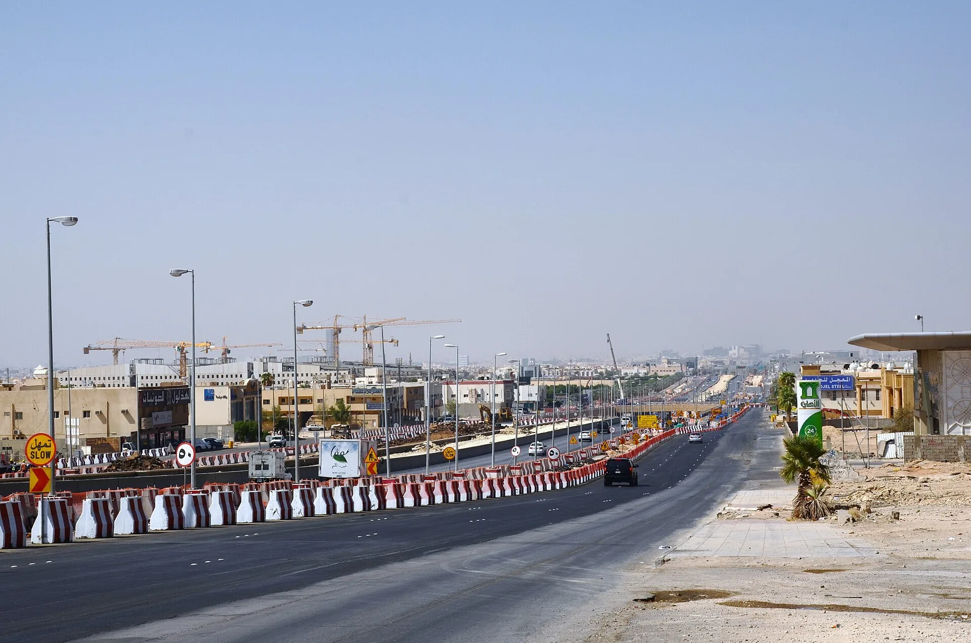 Street works with traffic management barriers on a Saudi arterial road